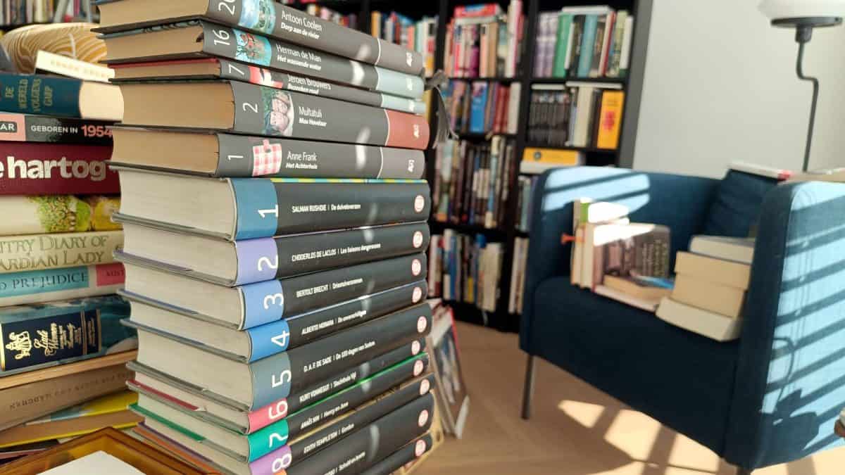 Books being arranged in rearranged in new bookcase